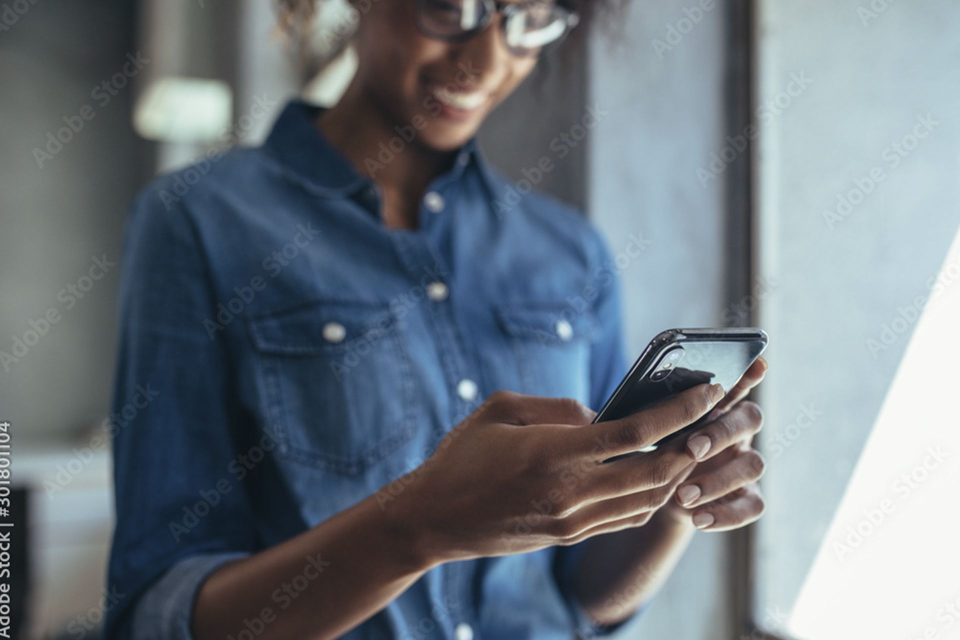 Woman looking at her cell phone, smiling