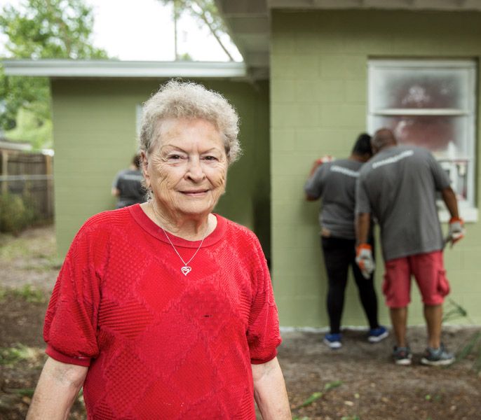 Homeowner smiling as Spectrum Housing Assist volunteers repair her home