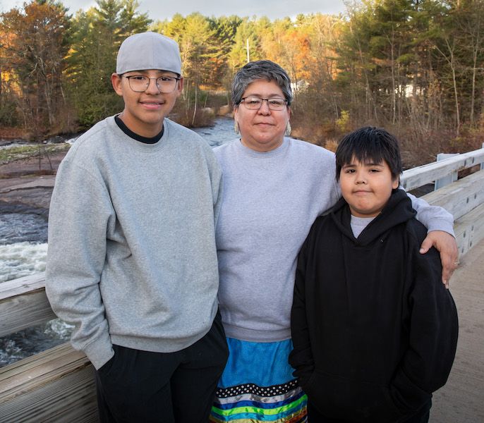 Menominee Indian family standing in the rural wilderness of Northern Wisconsin